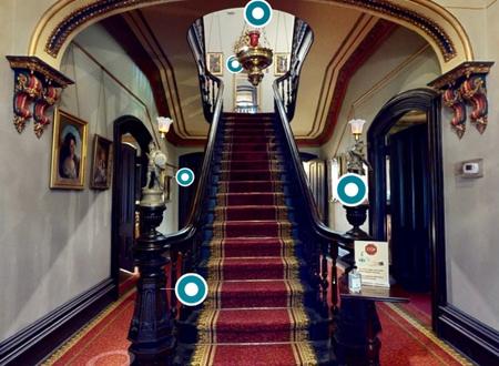 Image of Glanmore's front hall staircase with blue circular tags