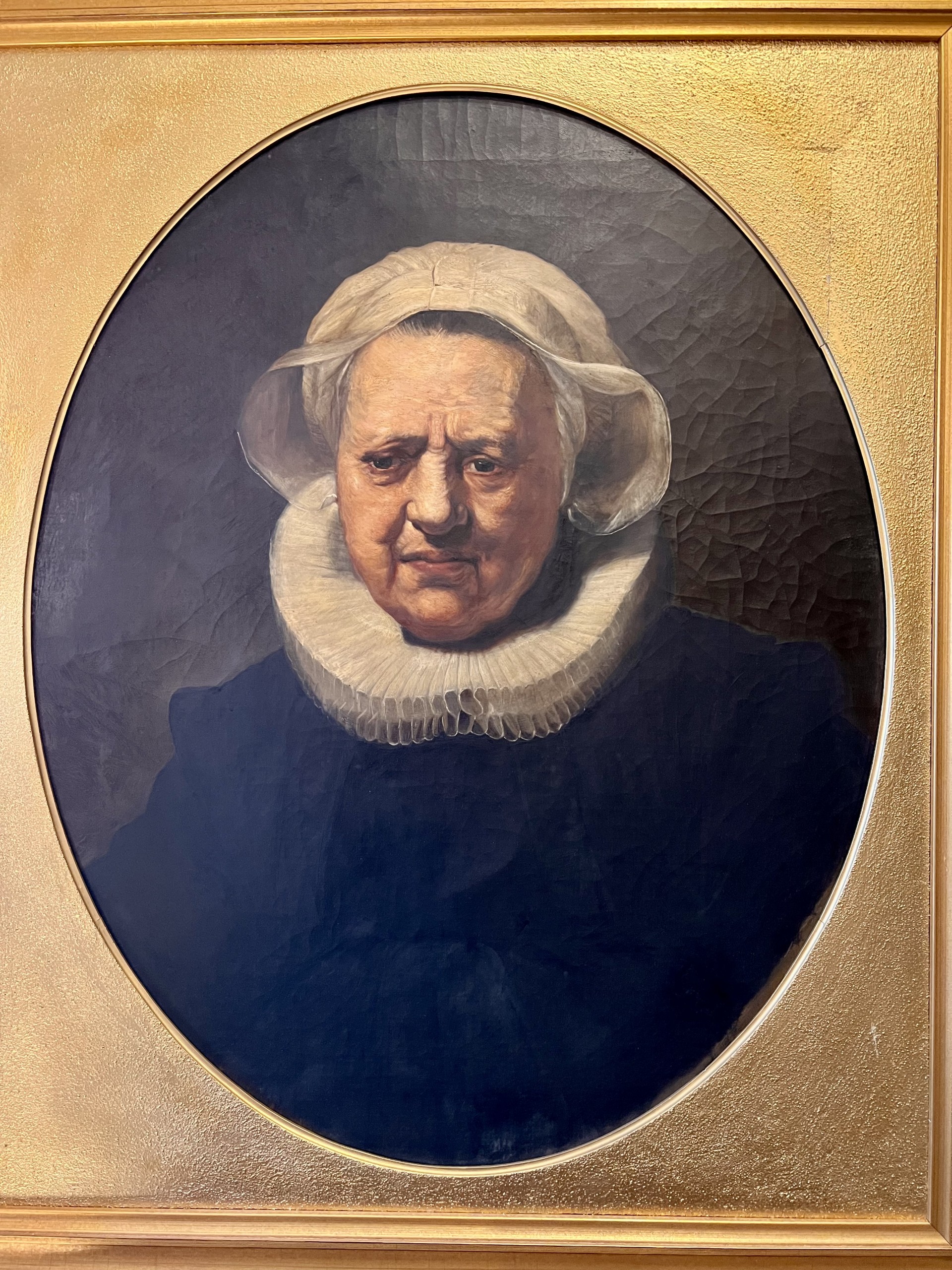 Oil painting of an old woman wearing a white neck frill. Copy of a Rembrandt painting attributed to Bertram Couldery. 