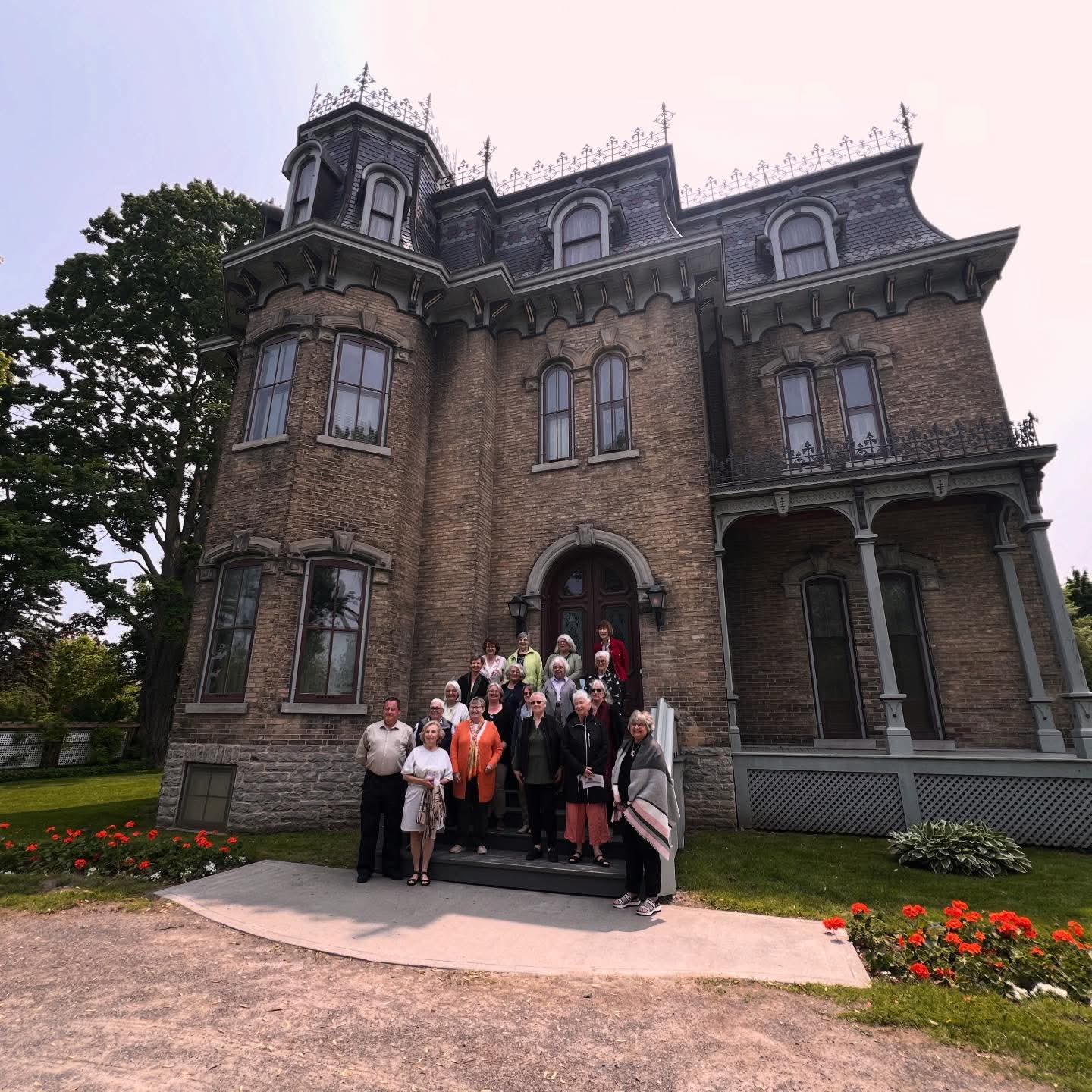 Exterior of Glanmore with group of people standing on front steps