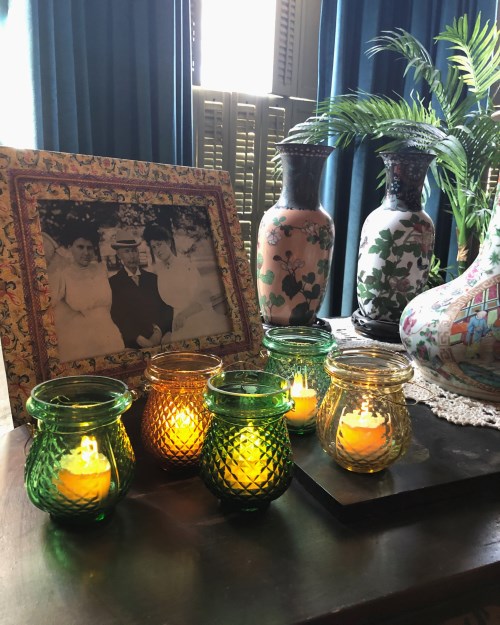 A grouping of five small glass candle holders known as fairy lamps.